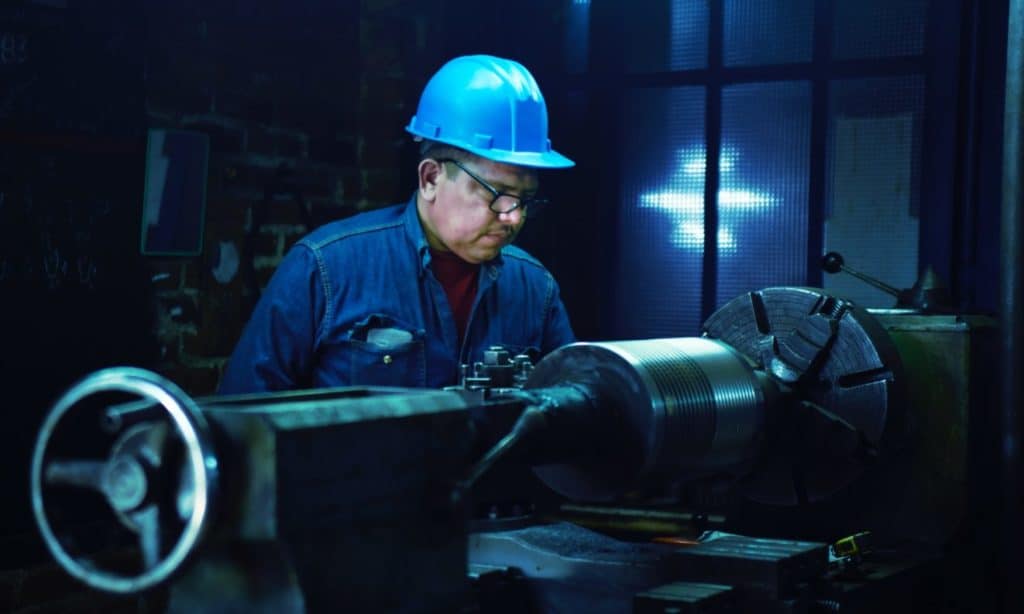 factory worker manufacturing a steering wheel