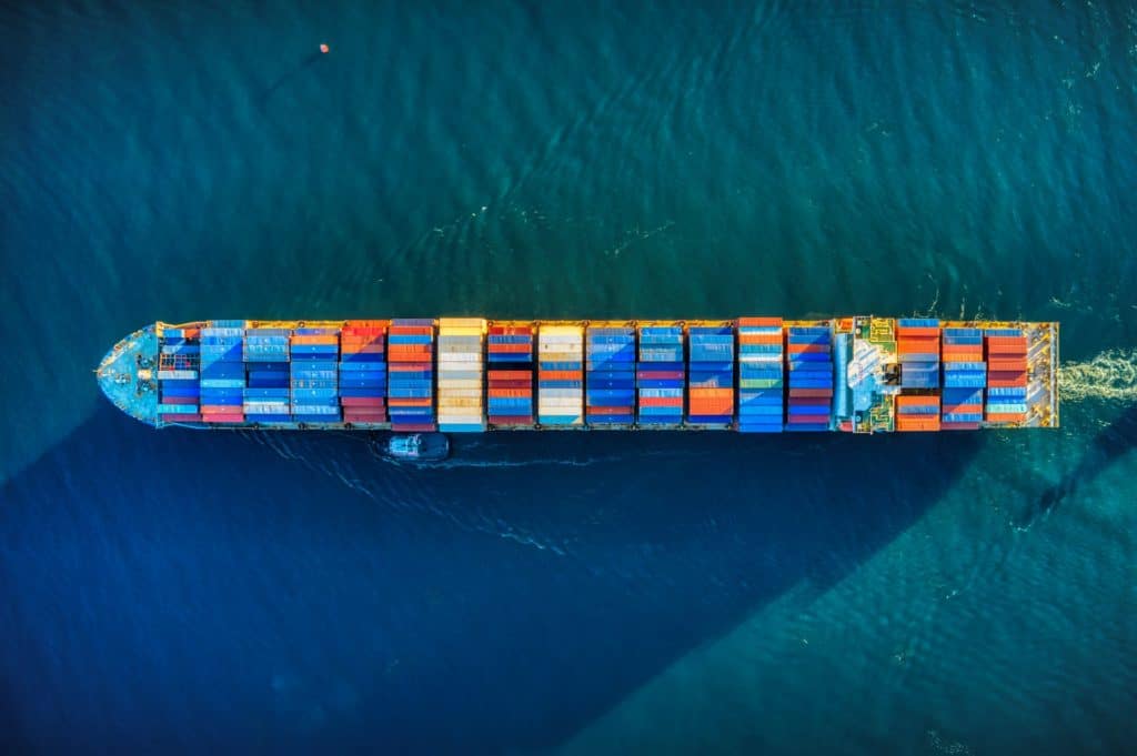 ship with shipping containers on the ocean